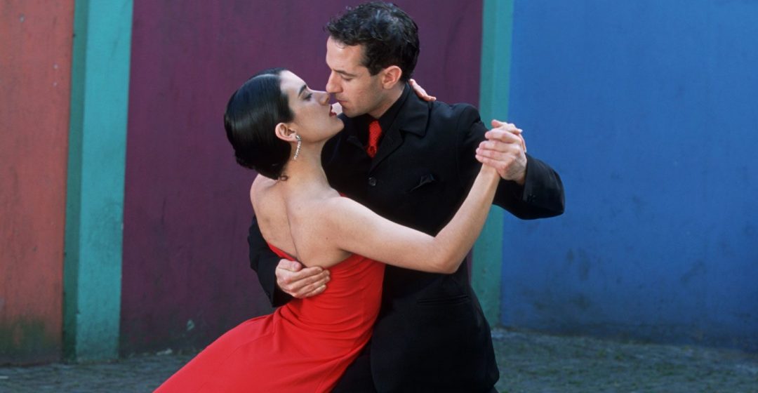 Dancing the Tango amid colorful walls of La Bocoa barrio, Buenos Aires, Argentina