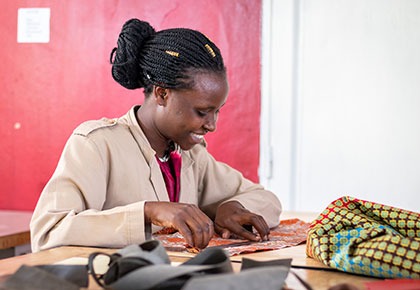 Beni sewing GeoEx luggage tags in Rwanda