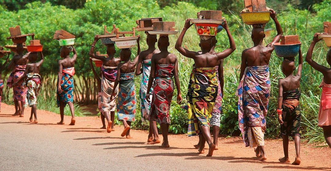 Women walking along road near Cotonou, Benin