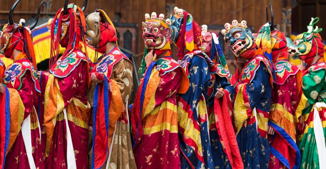 Masked dancers performing 'The Dance of the 16 Drum Beaters from Dramitse', at the Haa Tshechu, Bhutan