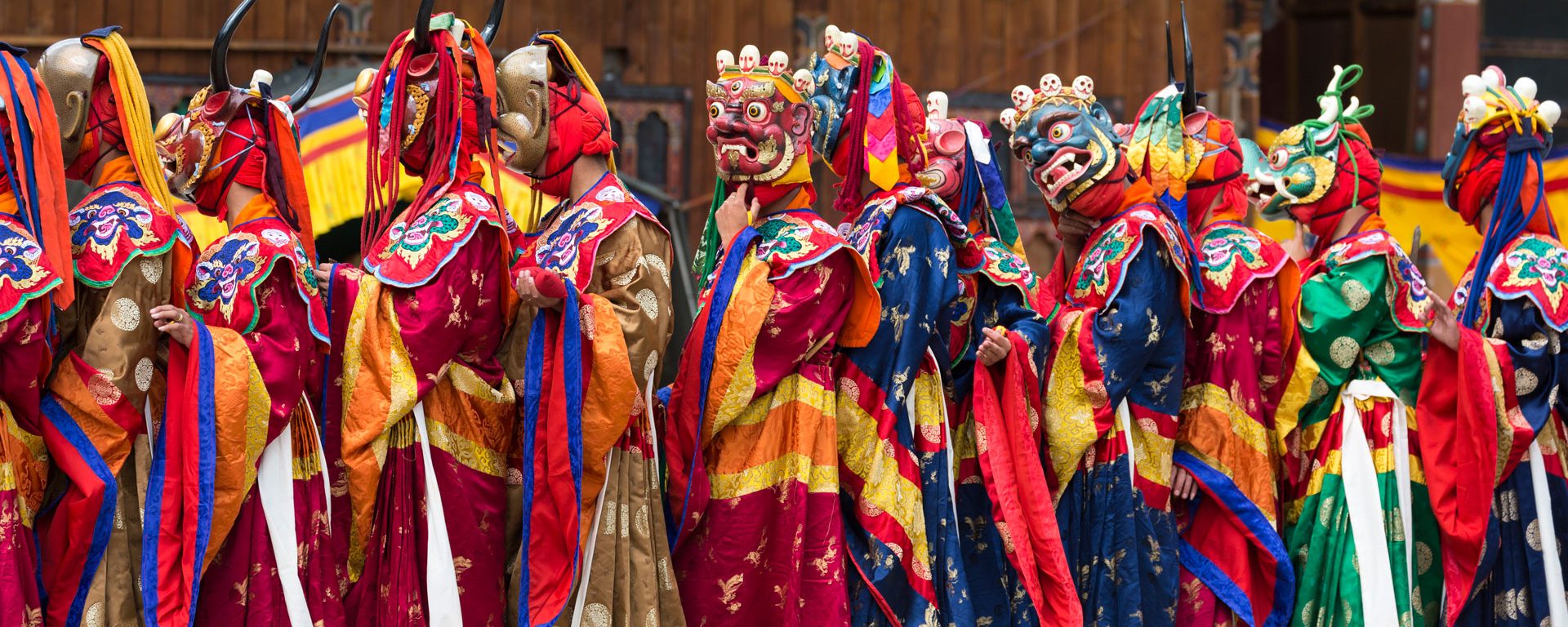 Masked dancers performing 'The Dance of the 16 Drum Beaters from Dramitse', at the Haa Tshechu, Bhutan