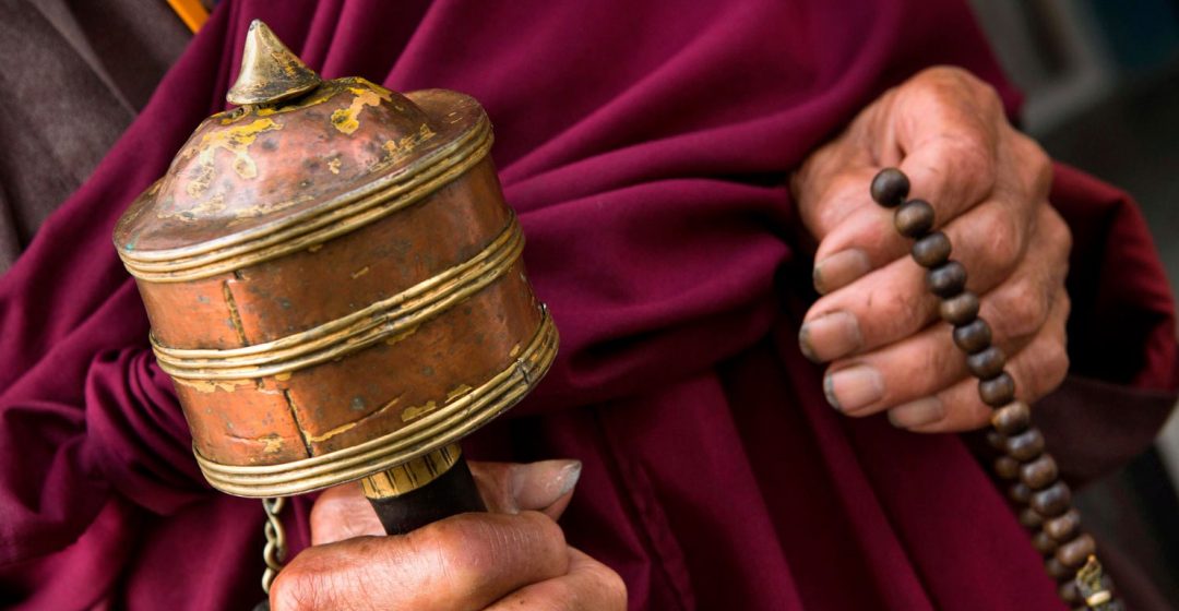 Hands of old monk holding prayer wheel and beads, Rangjung Monastery, Trashigang, Eastern Bhutan