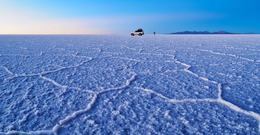 Vehicle on Salar de Uyuni at sunrise, Bolivia