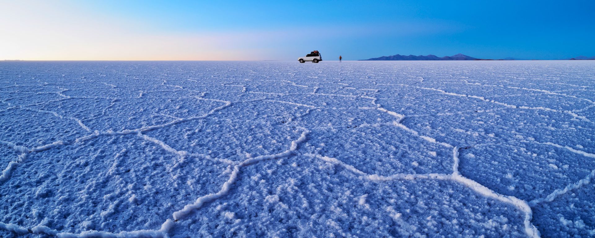 Vehicle on Salar de Uyuni at sunrise, Bolivia