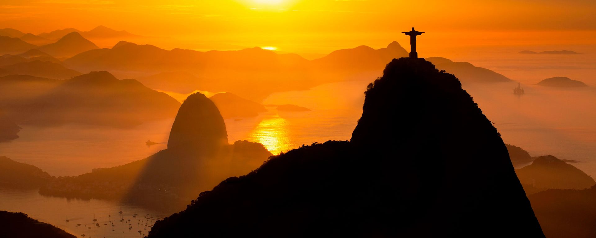 Rio de Janeiro landmarks: Christ the Redeemer and Sugar Loaf in the mist at sunrise, Brazil