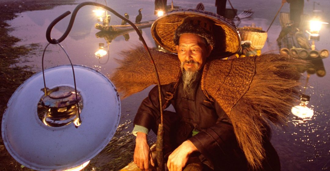 Cormorant fisherman on bamboo raft on the Li River, Guilin, China