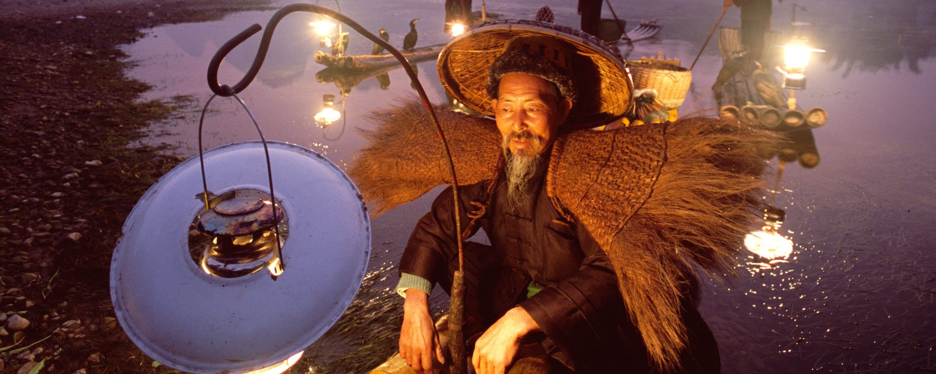 Cormorant fisherman on bamboo raft on the Li River, Guilin, China