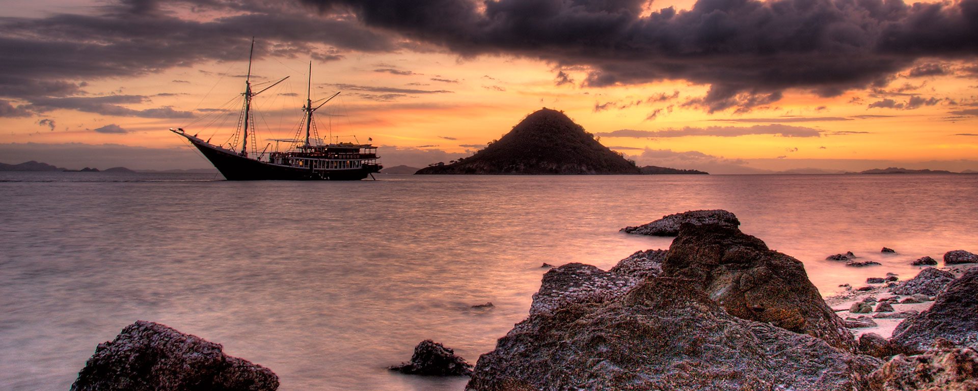 Phinisi schooner at sunset in Komodo National Park, Indonesia