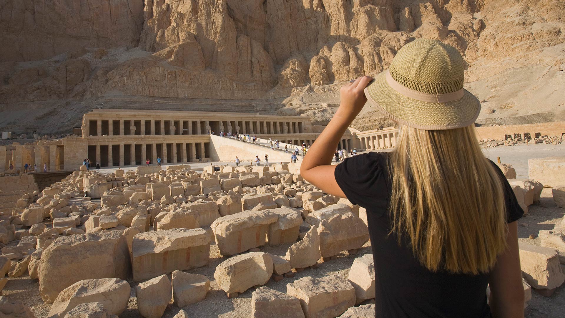 Woman gazes at the Temple of Hatshepsut in the Valley of the Kings and Queens, Egypt