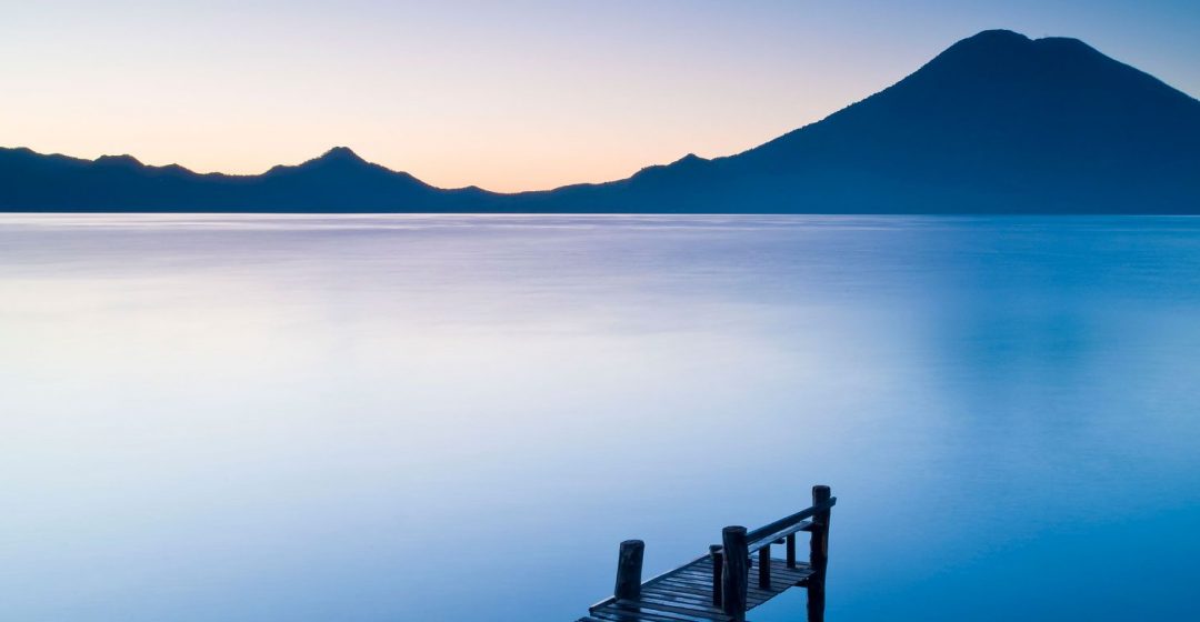 A wooden pier over Santa Cruz La Laguna, with mountain in the background, Lake Atitlan, Guatemala