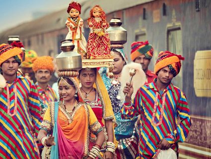 Colorfully dressed locals welcome the Deccan Odyssey train in Jaipur, India with GeoEx