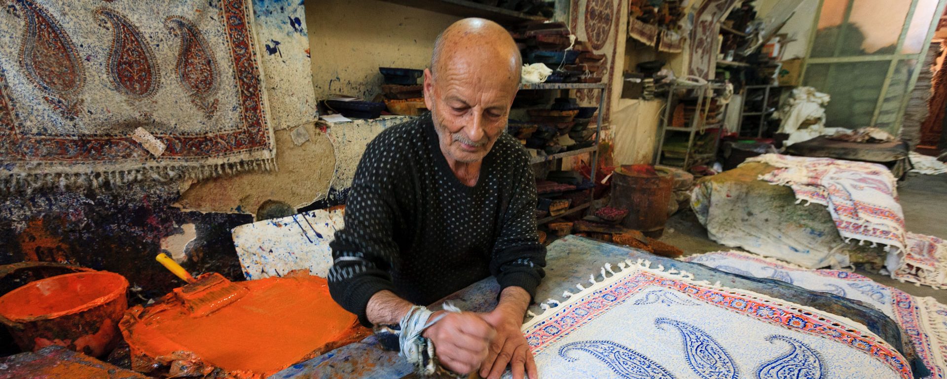 An artist crafts tapestries in his workshop, Iran