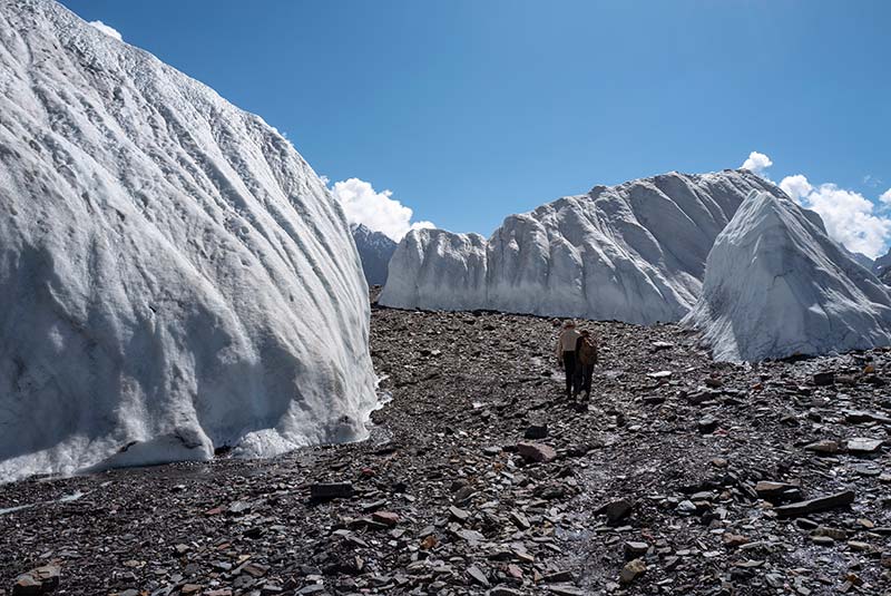 Trekkers hike through a glacier passage on the way to K2, Pakistan