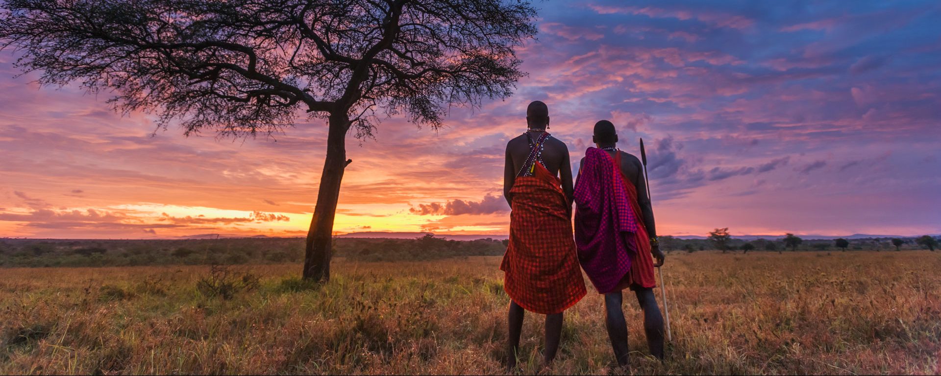 Two Maasai tribesman at dawn in the Masai Mara, Kenya