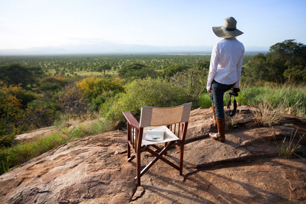 A young lady looks out over Meru National Park on safari in Kenya