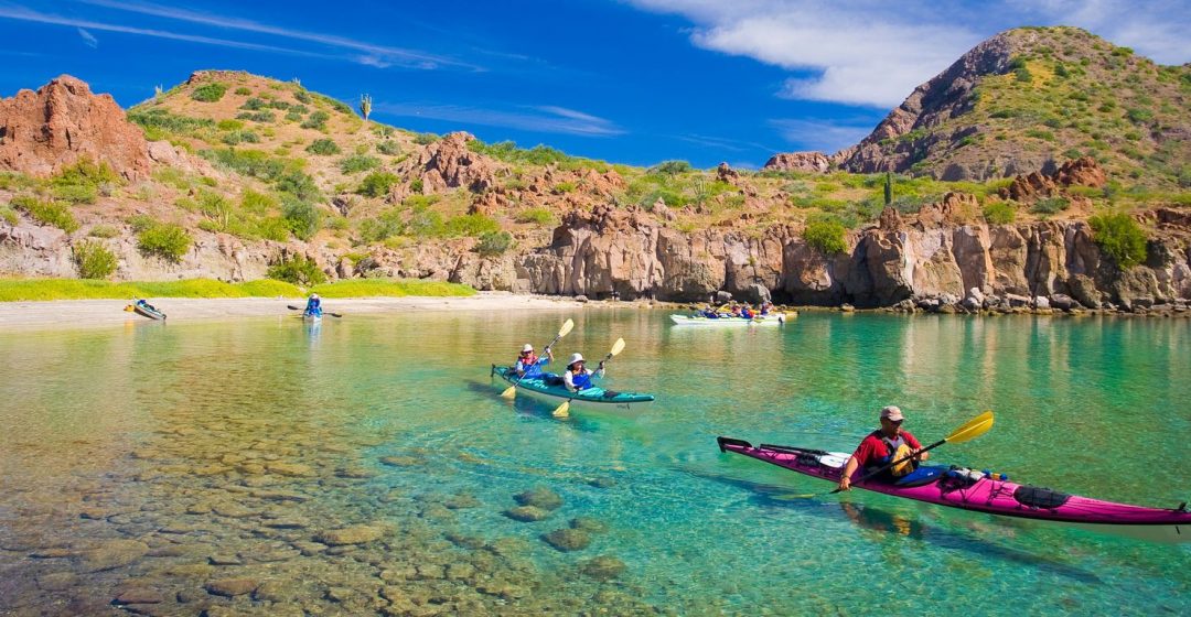 Sea Kayakers in crystalline waters, Honeymoon Cove, Baja, Mexico