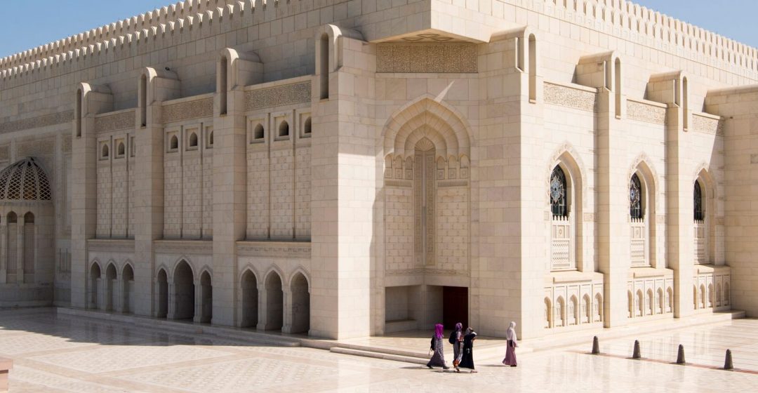 Omani women walking around the outside of the main Prayer Hall of The Sultan Qaboos Grand Mosque, Muscat, Oman