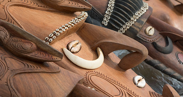 Carved wooden masks with shells and boar's tusks, Sepik River area, Papua New Guinea