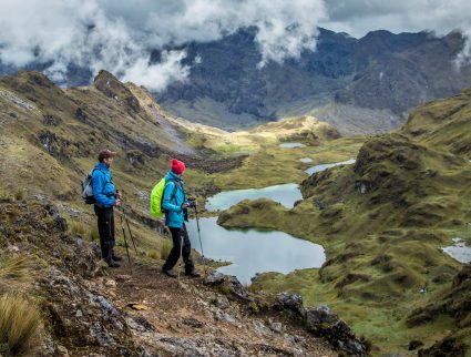 Hikers above a lake in the Lares Valley, Peru