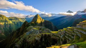 The suns rays shine on the Incan site of Machu Picchu, Peru