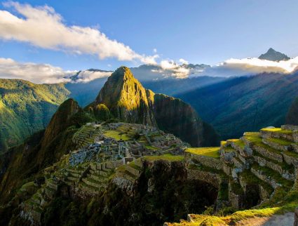 The suns rays shine on the Incan site of Machu Picchu, Peru