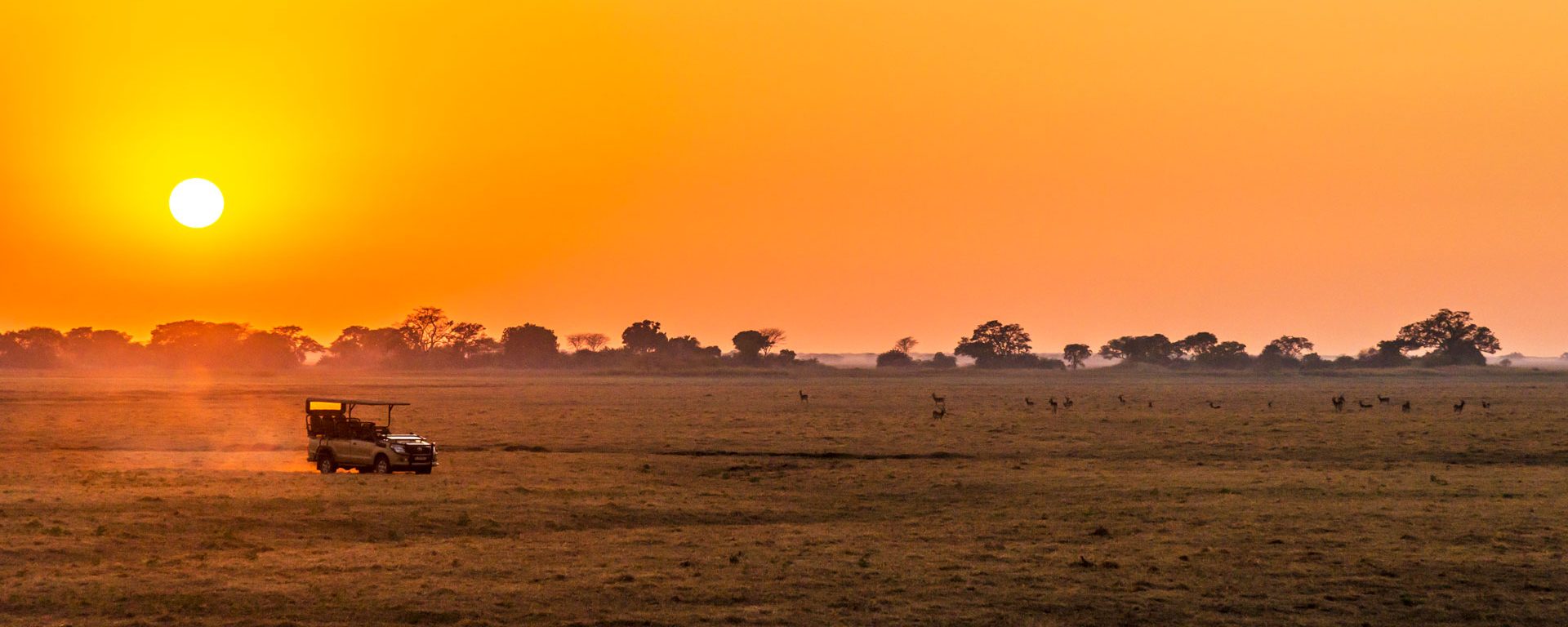 Safari vehicle at sunrise in Kafue National Park, Zambia