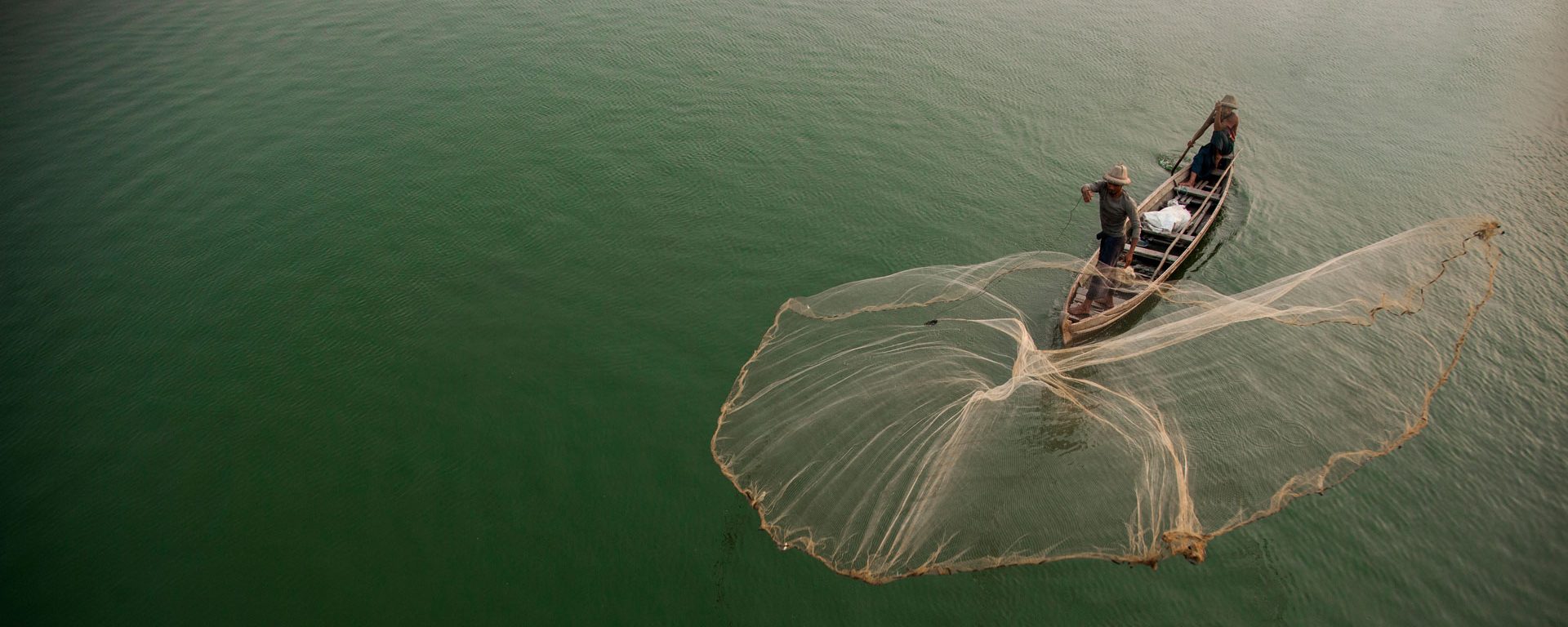 Myanmar, Mandalay, fisherman casting net on Irrawaddy River