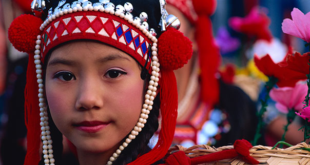 Akha hilltribe girl wearing silver head dress in Chiang Rai, Thailand