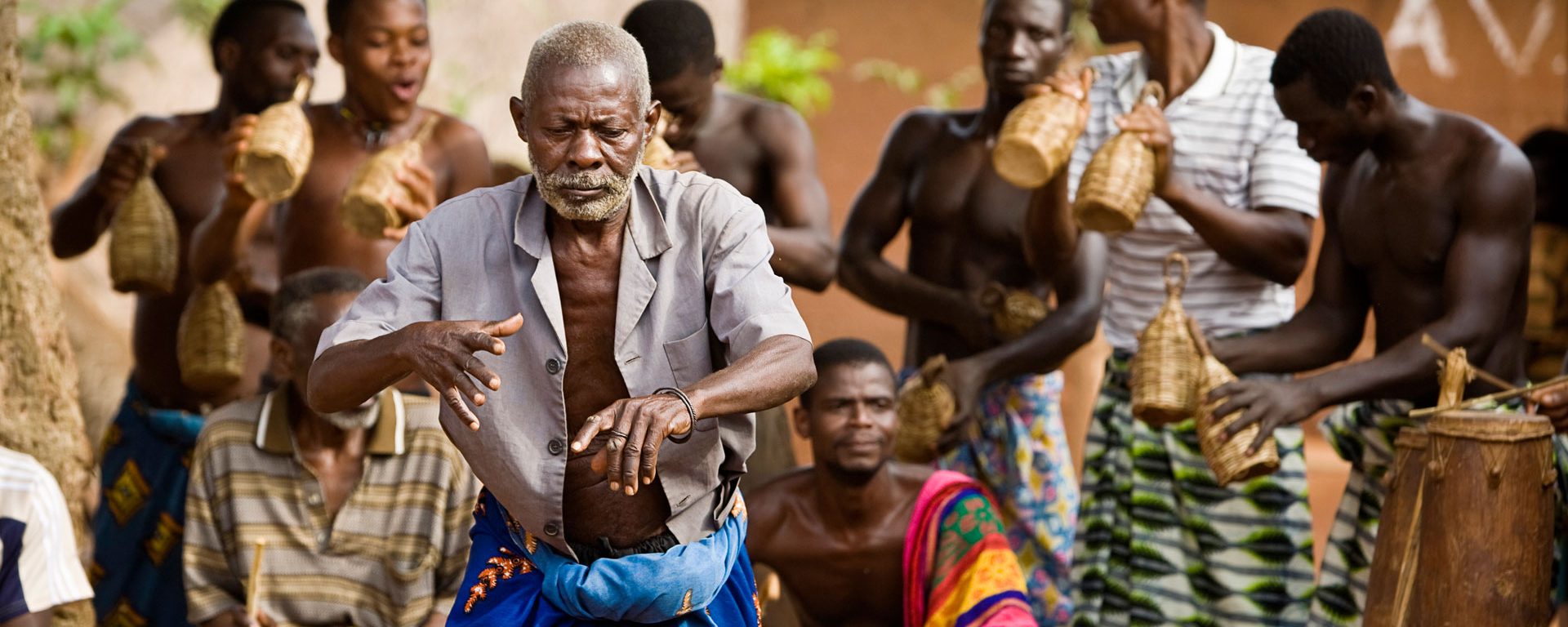 Village elder dancing with drummers during voodoo ceremony in Atitogan, Togo