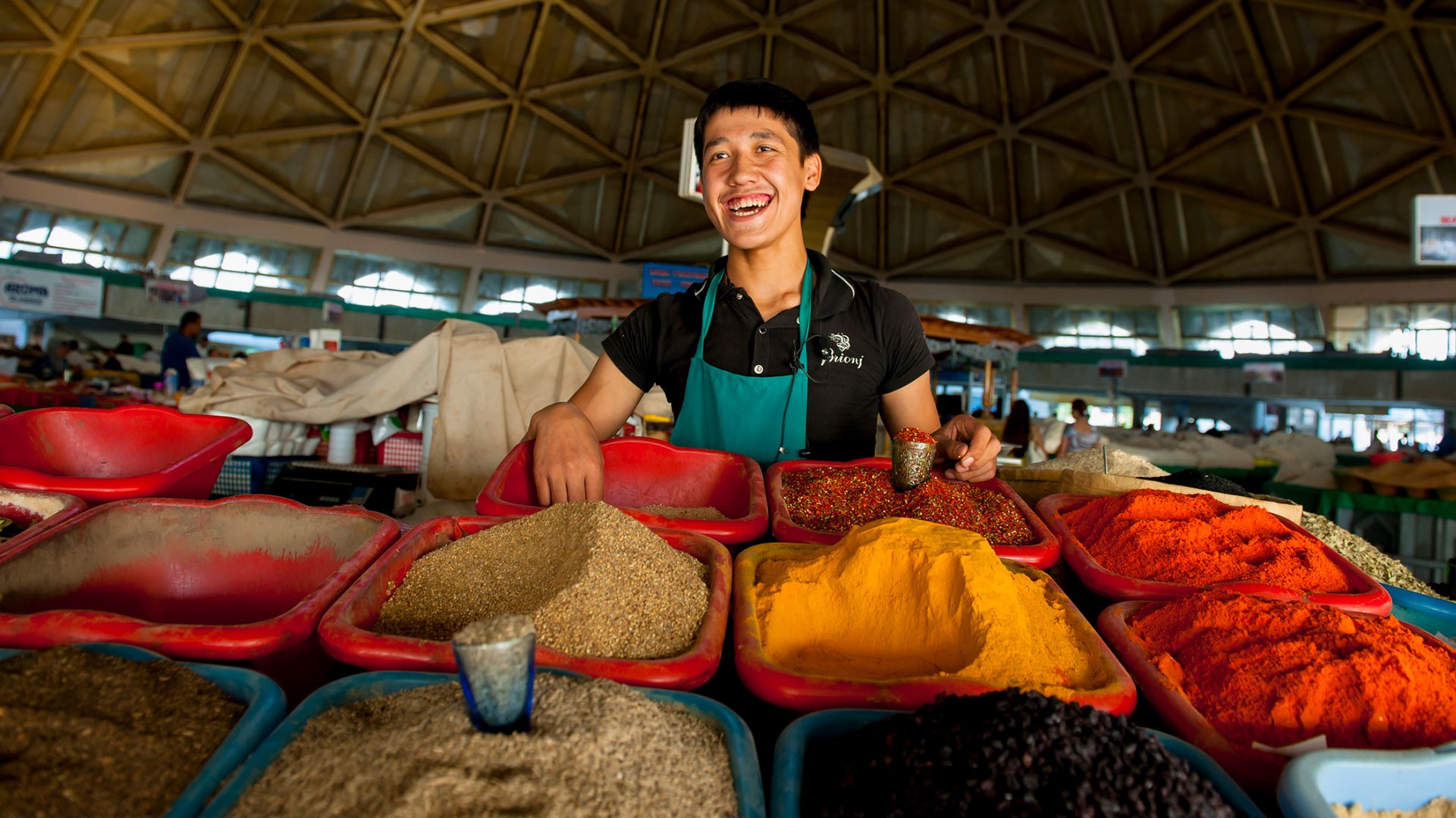 Man behind seasoning stand at Chorsu Bazaar in Tashkent, Uzbekistan